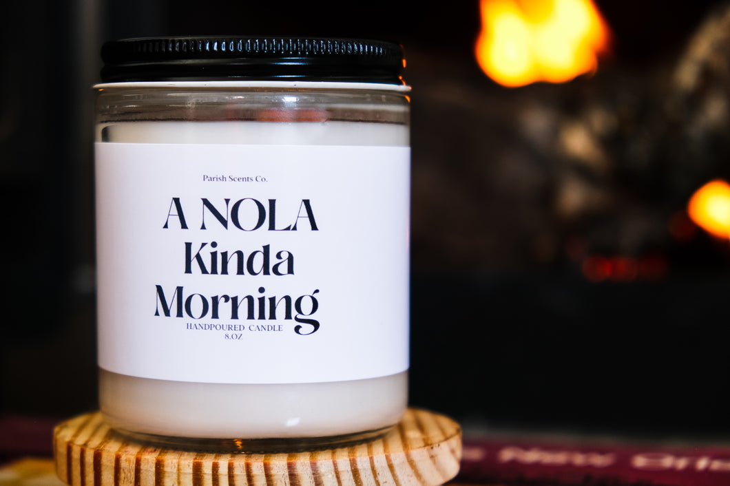 A NOLA Kinda Morning New Orleans Candle in a transparent 8 oz candle vessel