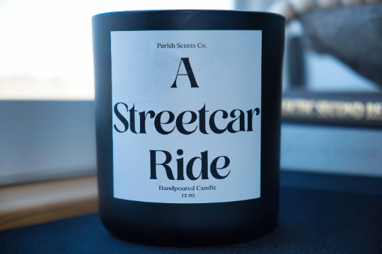 A Streetcar Ride New Orleans Candle in a solid black 12 oz candle vessel