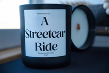 Load image into Gallery viewer, A Streetcar Ride New Orleans Candle in a solid black 12 oz candle vessel

